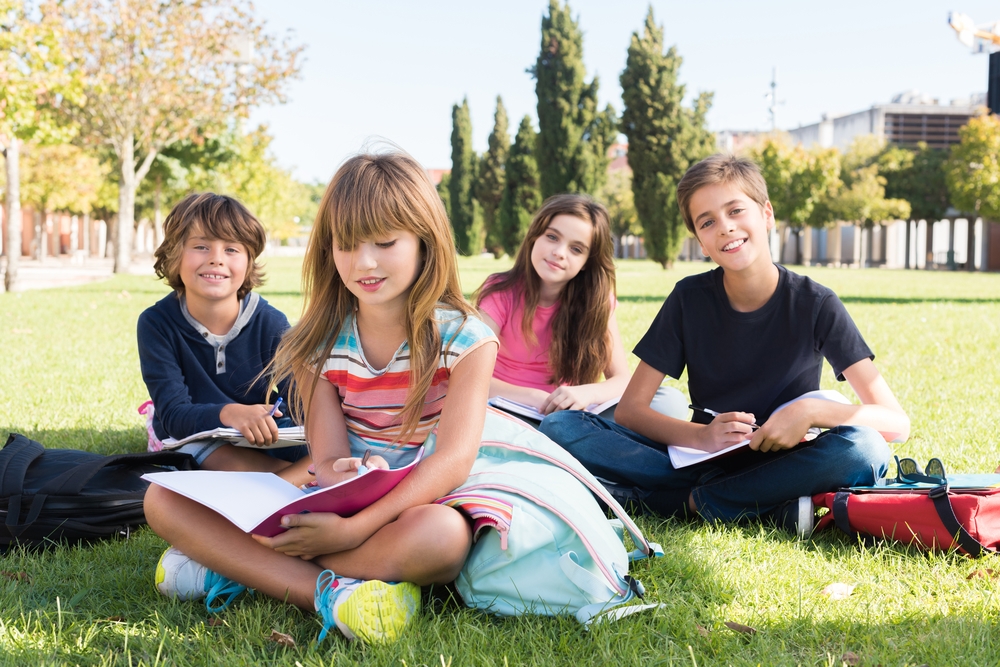 Group of happy school kids in school campus
