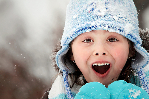 Surprised looking winter child portrait.